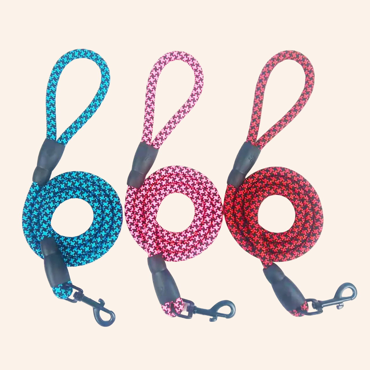 Four dog leashes in blue, pink, and red patterns on a white background